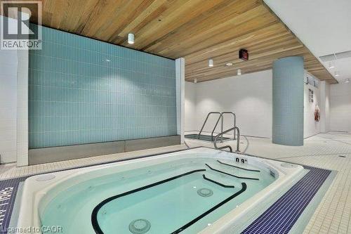 View of swimming pool featuring a hot tub - 55 Speers Road Unit# 415, Oakville, ON - 
