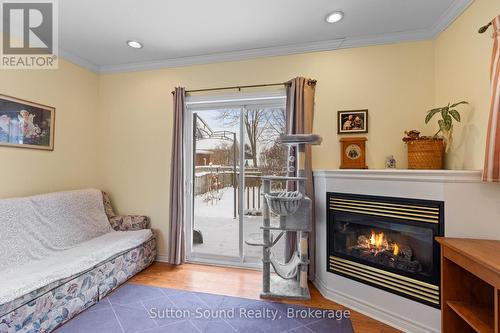Walk out to fenced backyard - 269 6Th Street E, Owen Sound, ON - Indoor Photo Showing Living Room With Fireplace