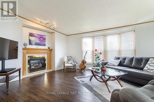Living Rm w/ Fireplace - 254 - 3033 Townline Road, Fort Erie (Black Creek), ON - Indoor Photo Showing Living Room With Fireplace