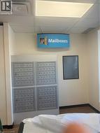 Surrounding community featuring a paneled ceiling and mail area - 