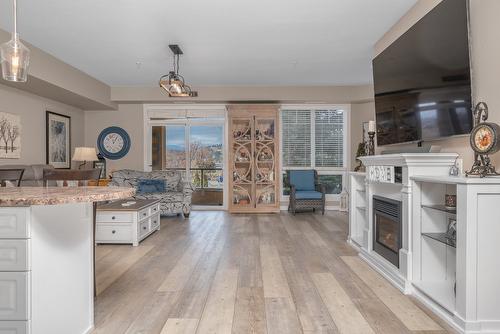 213-3550 Woodsdale Road, Lake Country, BC - Indoor Photo Showing Kitchen With Fireplace