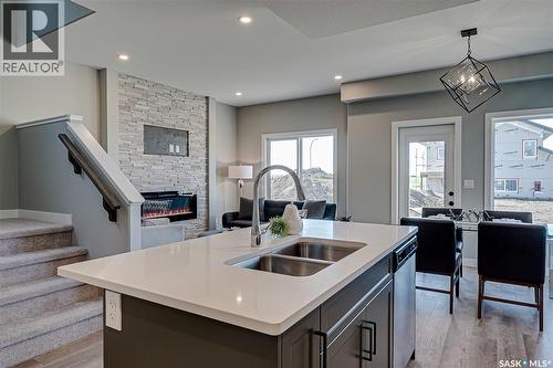 578 Traeger Manor, Saskatoon, SK - Indoor Photo Showing Kitchen With Fireplace With Double Sink