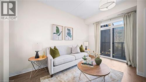 Living area featuring wood finished floors - 610 Farmstead Drive Unit# 304, Milton, ON - Indoor Photo Showing Living Room