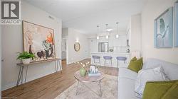 Living room featuring light wood finished floors and baseboards - 