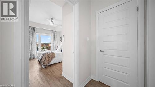 Bedroom with wood finished floors and ceiling fan - 610 Farmstead Drive Unit# 304, Milton, ON - Indoor