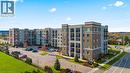 View of apartment building / complex with uncovered parking - 610 Farmstead Drive Unit# 304, Milton, ON  - Outdoor With Facade 