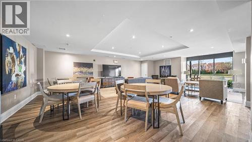 Dining space with a tray ceiling, light wood-style floors, and recessed lighting - 610 Farmstead Drive Unit# 304, Milton, ON - Indoor Photo Showing Dining Room