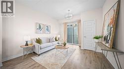 Living room featuring light wood finished floors and baseboards - 