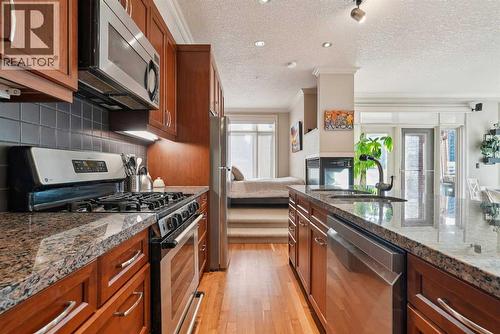 Stainless steel appliances - 306, 660 Eau Claire Avenue Sw, Calgary, AB - Indoor Photo Showing Kitchen With Stainless Steel Kitchen With Upgraded Kitchen