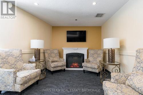 511 - 150 Dunlop Street E, Barrie, ON - Indoor Photo Showing Living Room With Fireplace