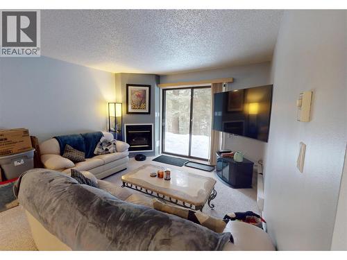 105A 1802 Alpine Drive, Elkford, BC - Indoor Photo Showing Living Room With Fireplace