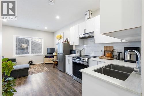 Basement - 224 River Heights Drive, Cochrane, AB - Indoor Photo Showing Kitchen With Double Sink