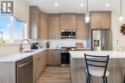 224 River Heights Drive, Cochrane, AB - Indoor Photo Showing Kitchen With Stainless Steel Kitchen With Upgraded Kitchen