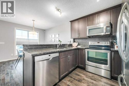 731, 101 Sunset Drive, Cochrane, AB - Indoor Photo Showing Kitchen With Stainless Steel Kitchen