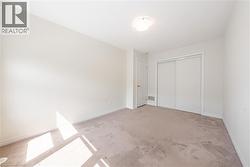 Unfurnished bedroom with light carpet and a closet - 