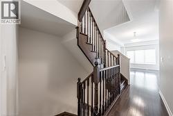Stairway featuring hardwood / wood-style floors and baseboards - 