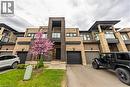 View of front facade with brick siding, driveway, and a balcony - 391 Athabasca Common, Oakville, ON  - Outdoor With Facade 