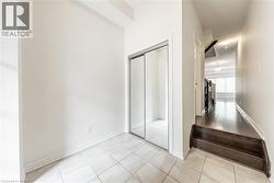 Corridor with baseboards and light tile patterned flooring - 