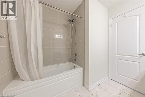 Bathroom featuring shower / bath combo and light tile patterned floors - 391 Athabasca Common, Oakville, ON - Indoor Photo Showing Bathroom