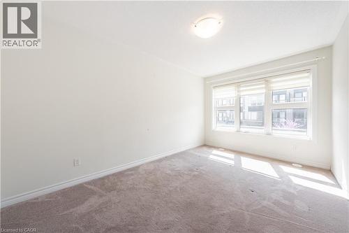 Carpeted spare room featuring baseboards - 391 Athabasca Common, Oakville, ON - Indoor Photo Showing Other Room