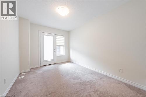 Carpeted empty room featuring baseboards and a textured ceiling - 391 Athabasca Common, Oakville, ON - Indoor Photo Showing Other Room