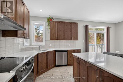 Ceramic tile backsplash 2 windows above sink - 204 Antler Court, Mississippi Mills, ON - Indoor Photo Showing Kitchen With Double Sink With Upgraded Kitchen