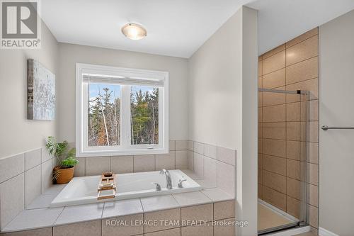 Relax after a long day in the large soaker tub - 204 Antler Court, Mississippi Mills, ON - Indoor Photo Showing Bathroom