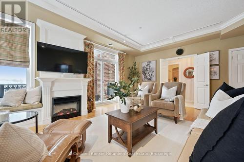 Cozy Fireplace for Wintery Nights - 202 - 65 Bayberry Drive, Guelph (Village By The Arboretum), ON - Indoor Photo Showing Living Room With Fireplace