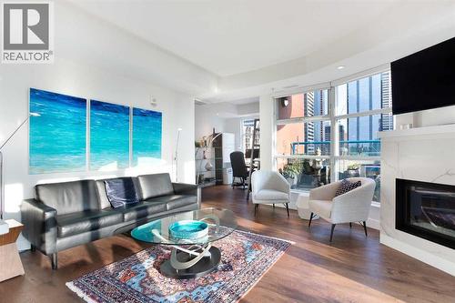 1005, 205 Riverfront Avenue Sw, Calgary, AB - Indoor Photo Showing Living Room With Fireplace