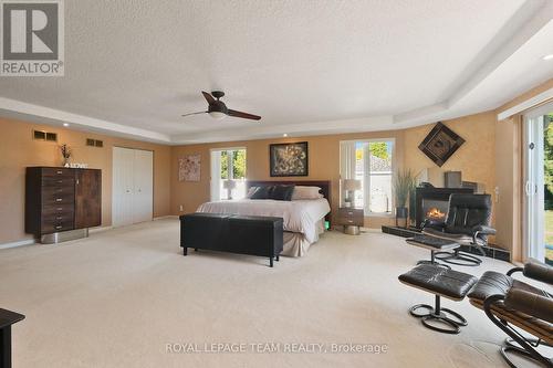 Primary bedroom features sitting area next to FPL. - 461 Campbells Side Road, Beckwith, ON - Indoor With Fireplace