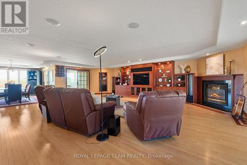 Massive great room finished with rich hardwood. - 461 Campbells Side Road, Beckwith, ON - Indoor Photo Showing Living Room With Fireplace