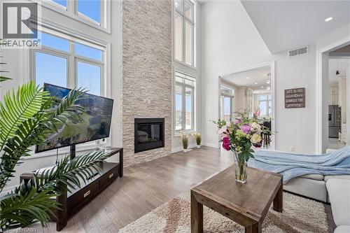 Living room featuring a fireplace, wood finished floors, and a towering ceiling - 263 Chestnut Ridge, Waterloo, ON - Indoor Photo Showing Living Room With Fireplace