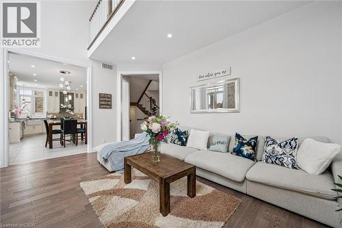 Living area featuring wood finished floors, recessed lighting, and stairway - 263 Chestnut Ridge, Waterloo, ON - Indoor Photo Showing Living Room