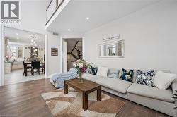 Living area featuring wood finished floors, recessed lighting, and stairway - 