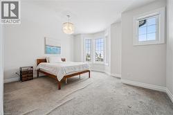 Bedroom featuring baseboards and carpet - 