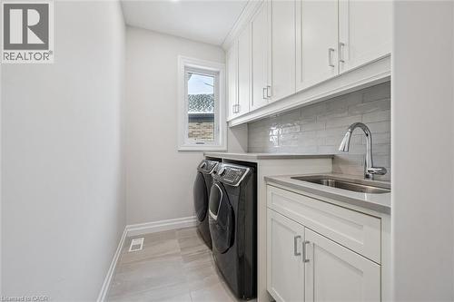 Laundry room featuring cabinet space and washing machine and dryer - 263 Chestnut Ridge, Waterloo, ON - Indoor Photo Showing Laundry Room