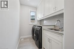 Laundry room featuring cabinet space and washing machine and dryer - 