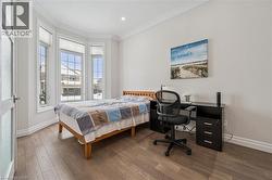 Bedroom featuring hardwood / wood-style floors, a desk, crown molding, and recessed lighting - 