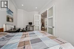 Bedroom with a desk, crown molding, and recessed lighting - 