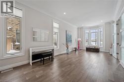 Sitting room featuring wood-type flooring, crown molding, and recessed lighting - 