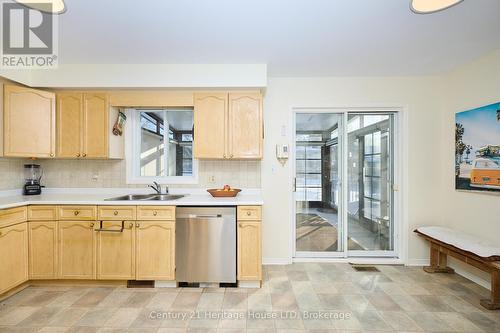 Sliding doors to sunroom - 3722 Sussex Lane, Fort Erie (Black Creek), ON - Indoor Photo Showing Kitchen With Double Sink