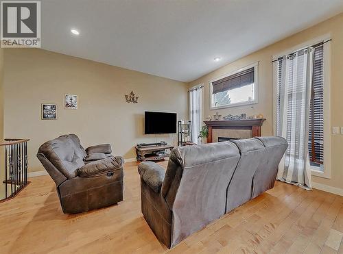 308 Lineham Acres Drive Nw, High River, AB - Indoor Photo Showing Living Room With Fireplace