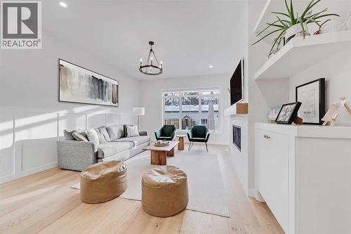 619 55 Avenue Sw, Calgary, AB - Indoor Photo Showing Living Room With Fireplace