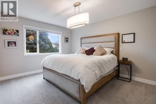 Spacious primary bedroom with walk-in closet and great natural light. - 1255 Raymer Avenue Unit# 507, Kelowna, BC - Indoor Photo Showing Bedroom