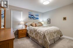 Generous second bedroom ideal for guests, office, or hobbies. - 