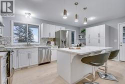 Functional kitchen with ample counter space, storage, and direct access to outdoor entertaining areas. - 