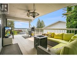 Spacious covered deck overlooking the valley and lake scenery, ideal for year-round entertaining. - 