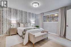 Generous primary bedroom offering comfort, privacy, and peaceful hillside surroundings. - 