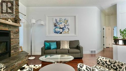 8245 102 Avenue, Peace River, AB - Indoor Photo Showing Living Room With Fireplace