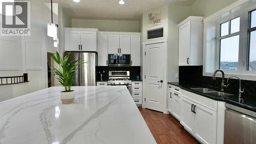 8245 102 Avenue, Peace River, AB - Indoor Photo Showing Kitchen With Double Sink